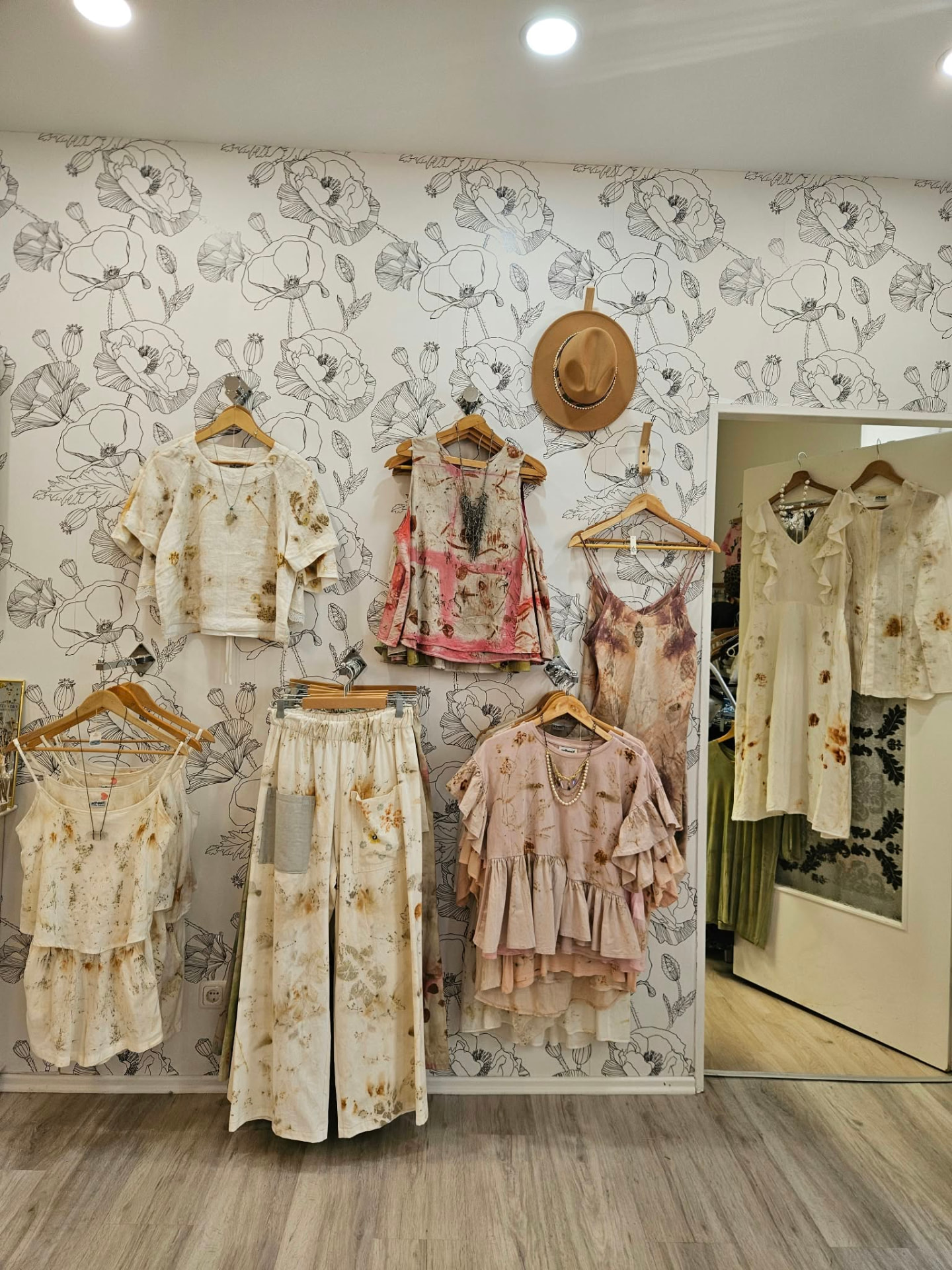 Botanical printing on reclaimed natural fibres in the atelier.