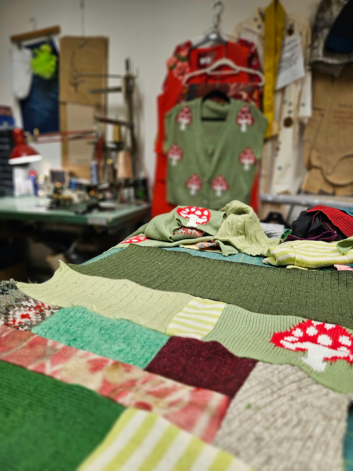 The Adhesif sewing studio, with patchwork in progress on the worktable.
