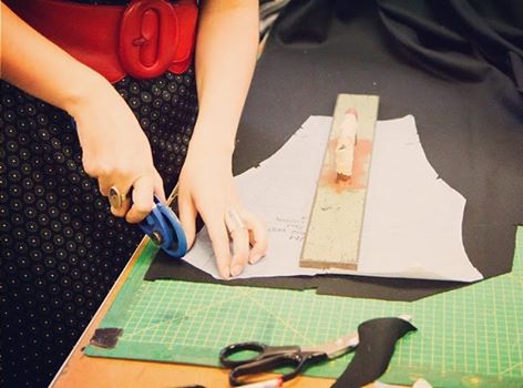 Hand-cutting reclaimed fabric in the Adhesif studio.